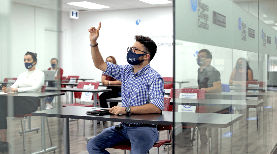 Student raising his hand during class