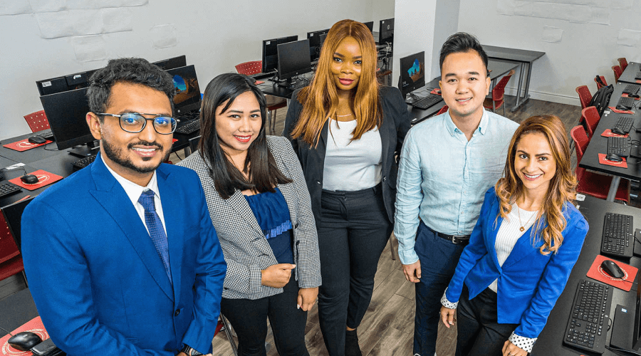 Students facing the camera and smiling