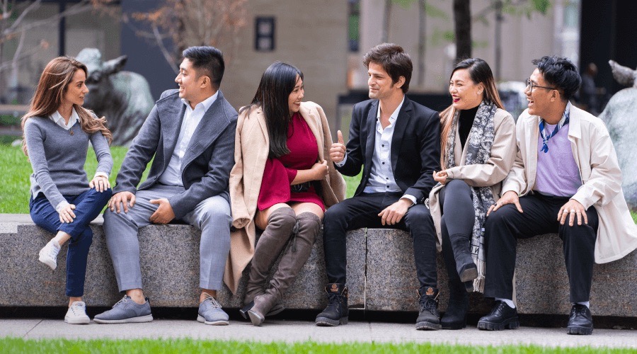 A small group of students sits around as they discuss together.